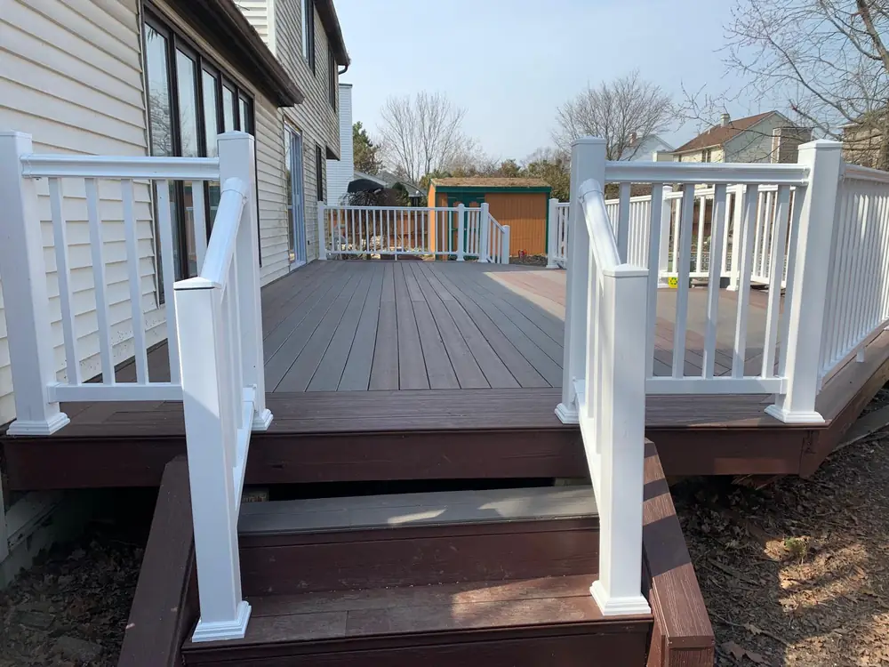 Composite deck and stairs with white vinyl railing in Buffalo NY