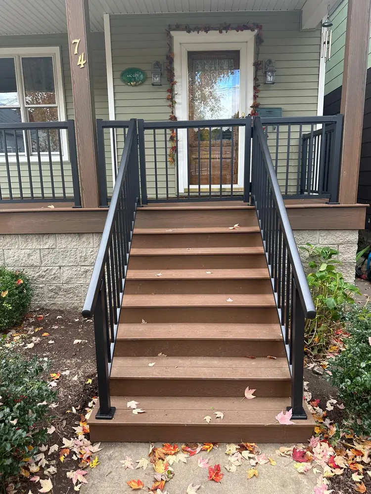 Composite porch steps with black aluminum railing in Buffalo NY