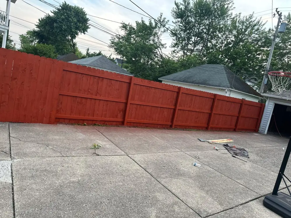 Privacy fence finished in a red stain in Buffalo NY